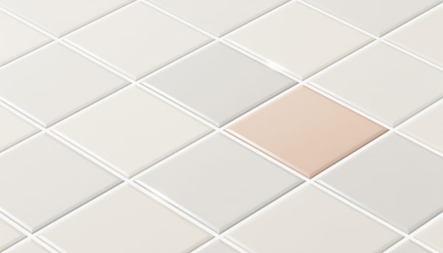 Close-up of clean bathroom tiles with fresh grout and a microfiber cloth nearby
